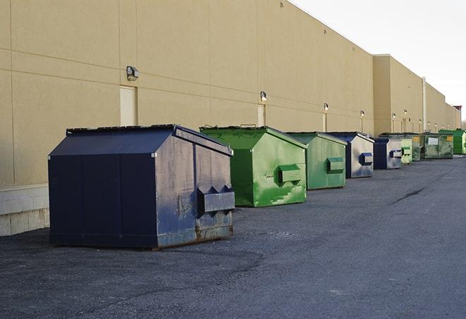 a construction worker moves construction materials near a dumpster in Eureka